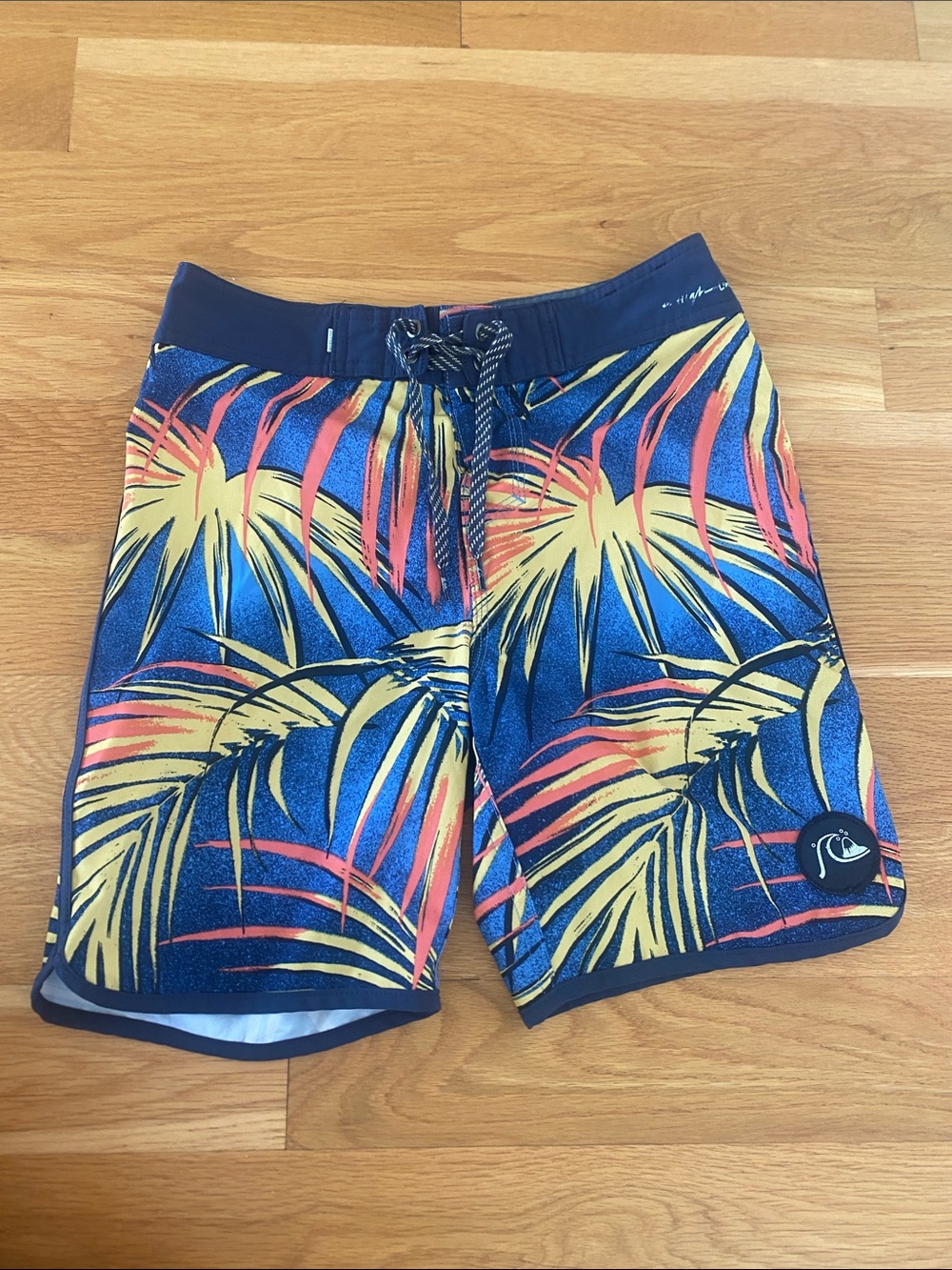 Quiksilver Navy Board Shorts with Yellow & Coral Palm Print. Size 26 or boys 12